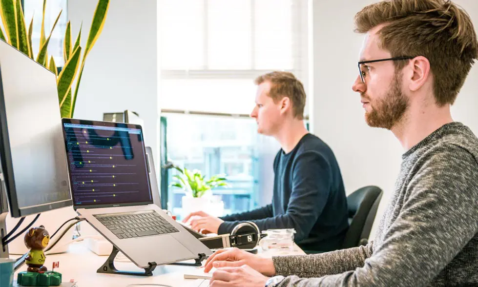 Two people are looking at their screens